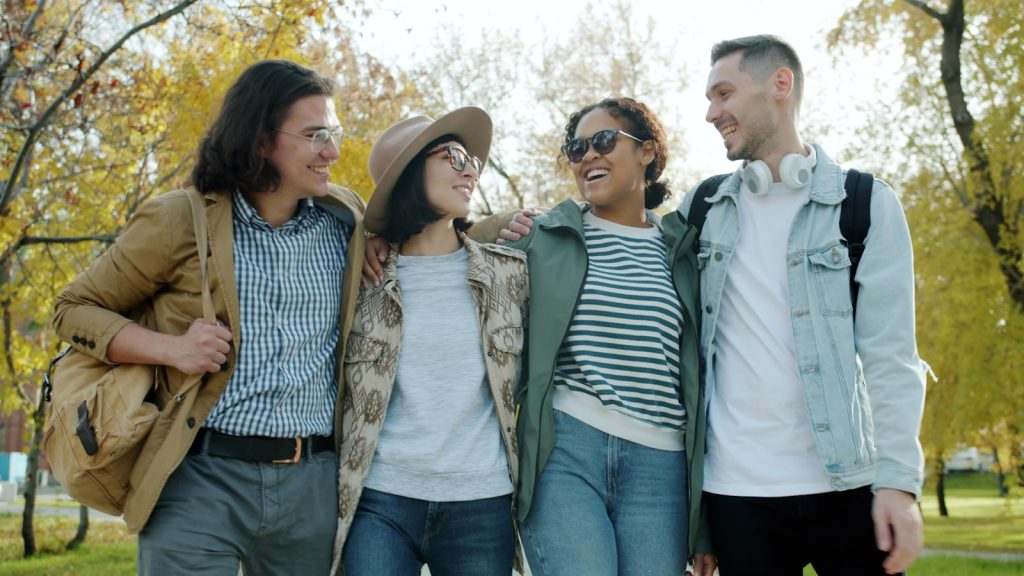 diverse group adults walking outdoors park